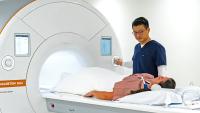 MRI Tech guides patient during MRI exam.